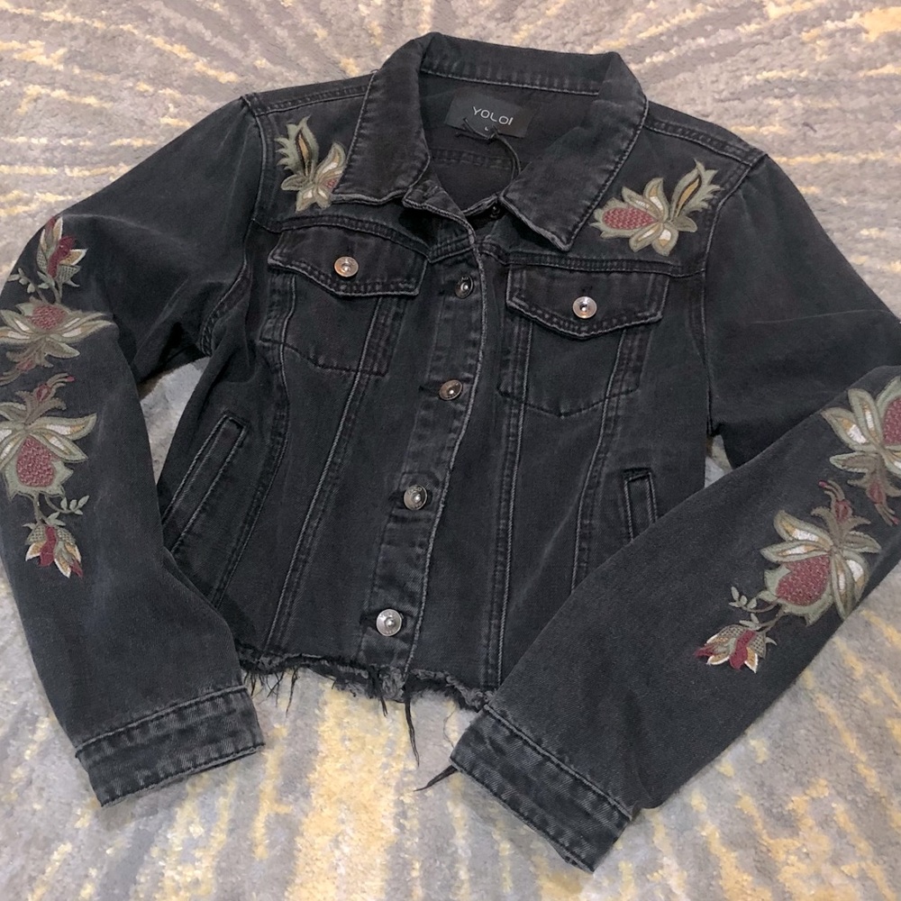 Embroidered sleeve detail on this black denim jacket